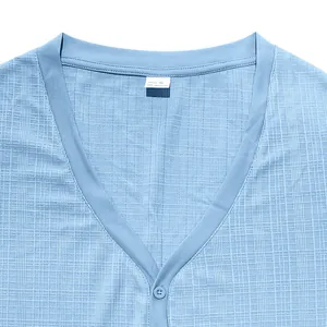 Close-up detail of the V-neckline and textured slub fabric on a light blue Henley shirt