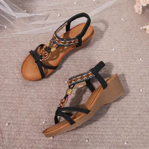 Detail view of Bohemian wedge sandals with intricate rhinestone and bead decorations.