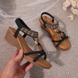 Bohemian wedge sandal with intricate beaded straps and decorative floral charms