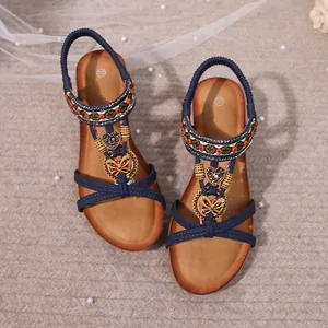 Detailed view of Bohemian wedge sandals with colorful beads and butterfly charms