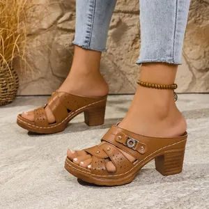 Brown platform high-heel mule sandals with buckle detail and peep-toe design.