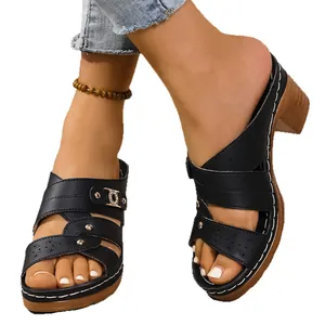 Stylish black platform sandals with chunky high heels and elegant laser-cut strap details