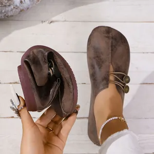Detailed macro view of flexible soft leather women's flat loafers in vintage brown finish