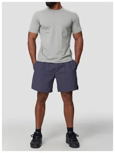 Men's athletic grey crew neck t-shirt and navy shorts set shown in a studio setting