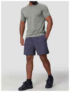 Athletic fit of a men's grey quick-dry crewneck T-shirt for hiking and sports