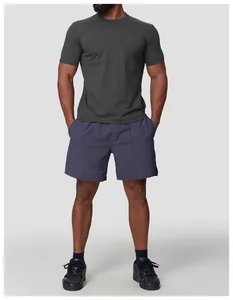 Full shot of an athletic man in a dark gray moisture-wicking quick-dry sports T-shirt.