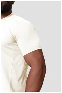 Detail of cream men's quick-dry sports t-shirt showing breathable fabric and sleeve fit