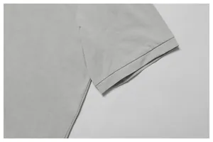Detailaufnahme des Ärmelbündchens eines hellgrauen, schnelltrocknenden Golf-Poloshirts.