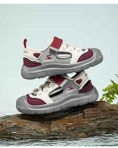 Detail view of boys' 2025 closed-toe summer mesh sports sandals stacked on wood