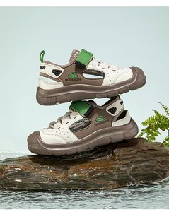 Detailed view of children's non-slip river sandals on wet rock with water splashes