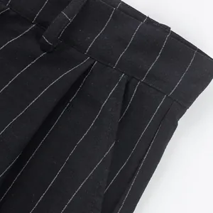 Macro detail view of men's black pinstripe linen trousers showing waist and pocket