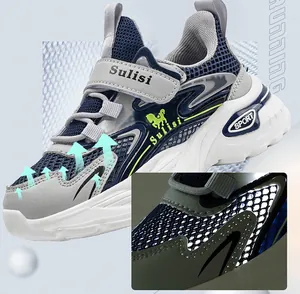 Detailed view of breathable mesh fabric on boys' blue and grey sports running sneakers.