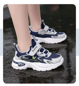 Close-up of boys' breathable mesh running shoes with velcro straps on wet ground