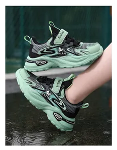 Detailed side view of mint green and black breathable mesh running shoes for boys outdoors