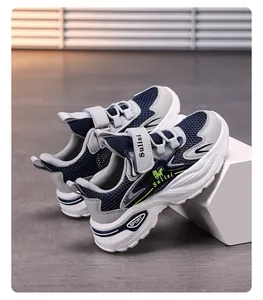 Detail view of boys' breathable navy blue and grey mesh sneakers with green accents.