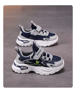 Side view of breathable mesh boys' sports shoes with navy blue and grey details