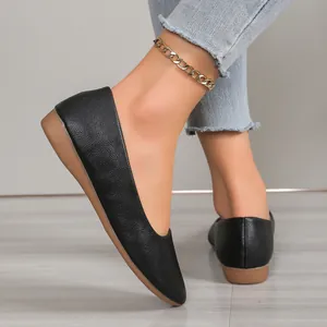 Close-up of black pointed-toe flat shoes featuring a comfortable and minimalist design