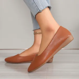 Detailed side view of elegant brown pointed-toe flat shoes for women with soft leather