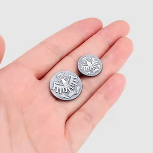 High-end vintage metallic buttons featuring an embossed eagle crest design, shown in hand