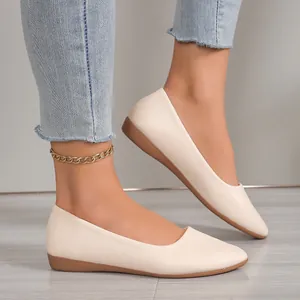 Elegant beige pointed toe flat shoes for women styled with a casual denim outfit