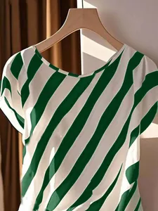 Elegant green and white diagonal striped plus size women's top displayed on hanger