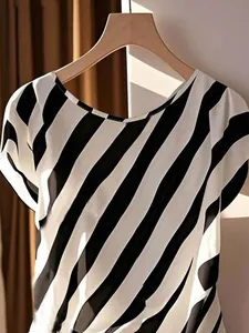 Detail of elegant women's black and white diagonal striped top with soft fabric texture.