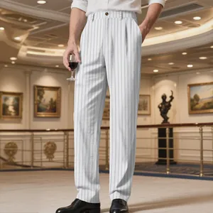 Men's loose white linen striped trousers shown in a professional lifestyle setting