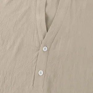 Detailed close-up of white buttons and linen fabric texture on men's beige shirt