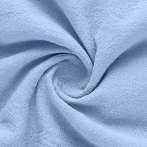 Detailed macro view showing the breathable texture of light blue linen fabric for men's shirts