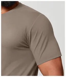 Close-up detail showing the fabric texture and sleeve seam of a men's khaki sports T-shirt