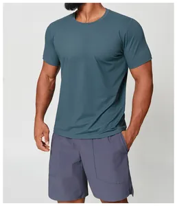 Detail shot of a man wearing a teal quick-dry athletic t-shirt for fitness and hiking sports.