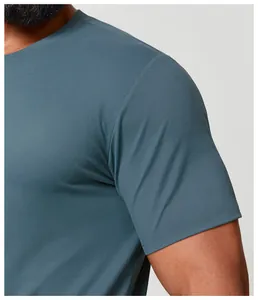 Detailed macro view of the breathable teal quick-dry sports T-shirt fabric and shoulder