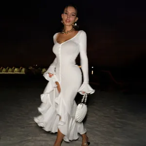 Detailed view of white ruffle split dress with V-neck and buttons at night beach