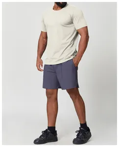 Professional model wearing a men's beige quick-dry sports t-shirt and grey shorts