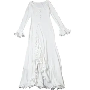 Full view of white slim fit maxi dress with V-neck, long ruffle sleeves and high slit.
