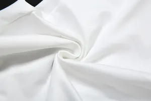 Detailed close-up showing the soft and high-quality white fabric texture of the V-neck dress