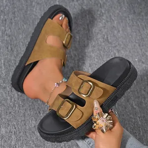 Detailed close-up of stylish khaki platform slide sandals with double gold buckles