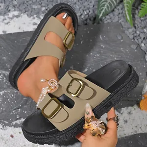 Close-up detail of khaki double buckle platform sandals featuring a thick black sole.