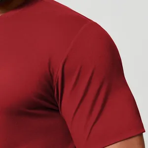Macro detail of a men's dark red quick-dry sports T-shirt showing fabric and shoulder
