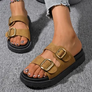 Close-up view of women wearing stylish brown platform sandals with double gold buckles