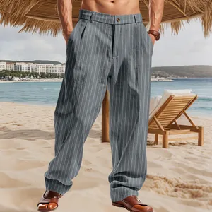 Detailed view of men's striped linen casual trousers in a beach setting