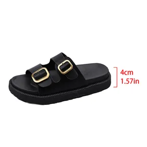 Close-up of black platform slide sandal with double gold buckles and 4cm heel height