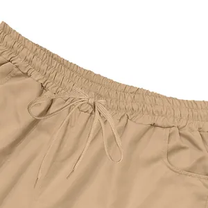 Close-up view of the elastic drawstring waistband on khaki mens casual cargo shorts.