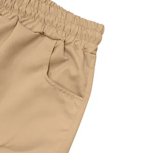 Close-up detail of elastic waistband and pocket on khaki cargo shorts