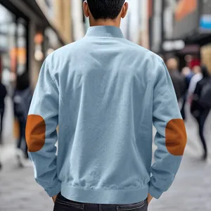 Back view of light blue retro corduroy jacket with contrasting brown elbow patches