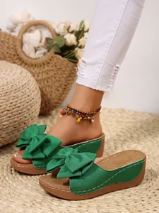 Detailed view of stylish green bow platform sandals for women in summer