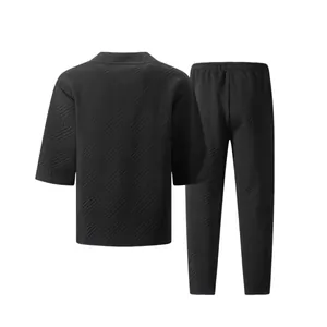 Back view of men's casual black set featuring a textured geometric jacquard pattern.