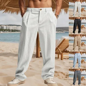 Detailed view of men's striped linen trousers in various colors at beach