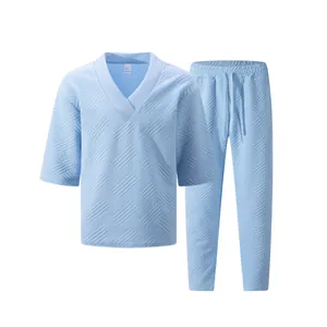 Detail view of light blue men's casual V-neck shirt and pants set with jacquard texture