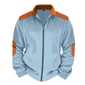 Detail of men's blue corduroy jacket with orange patchwork and front zipper closure